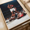A framed poster depicting a boxing match with two fighters in the ring.