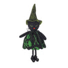 A black witch ornament with a green pointed hat and skull design.