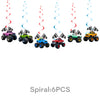 Six colorful monster truck figurines are displayed against a backdrop of swirling red and blue streamers.