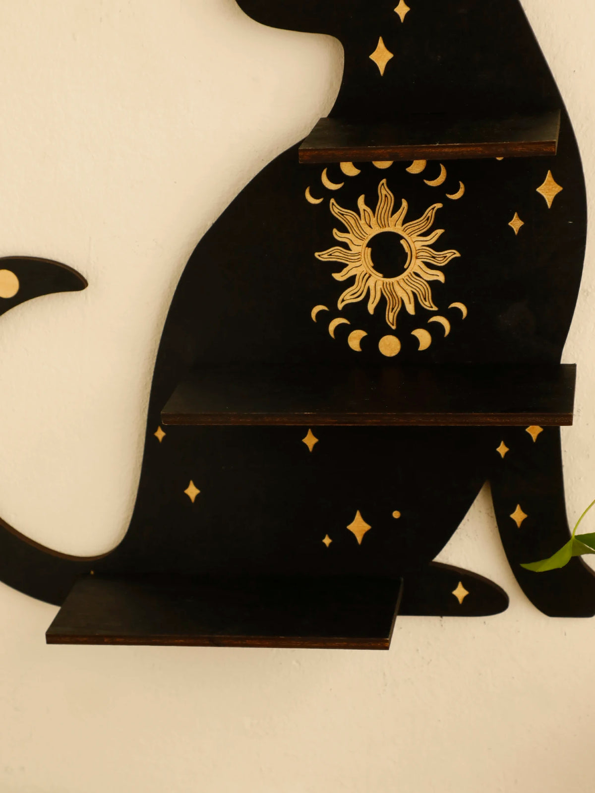 A black cat silhouette floating shelf featuring a sun motif and gold stars for crystals and decor.