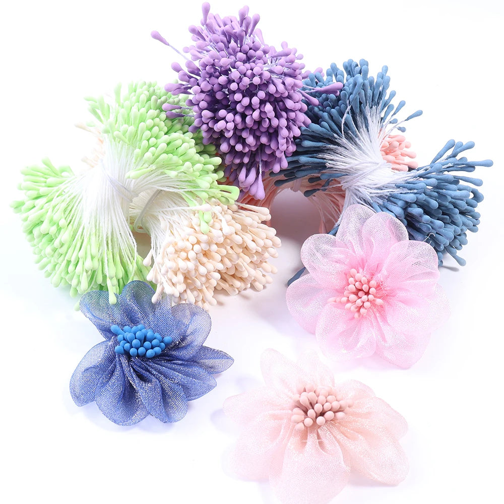 A collection of mini artificial flower stamens in various shades of purple, green, blue, and pink.