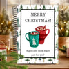 A spiral-bound gift card book featuring a festive Christmas design with a mug and evergreen trees.