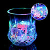 A glass cup filled with glowing blue and pink liquid, featuring an LED glow effect.