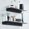 Black floating metal wall shelves displaying various bathroom and kitchen storage items like toothbrushes and plant pots