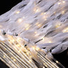 LED glow wands with ribbons and bells draped in sheer white fabric for weddings and parties