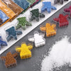 A collection of handmade candle wax kits featuring various colored sand pigments in glass containers.