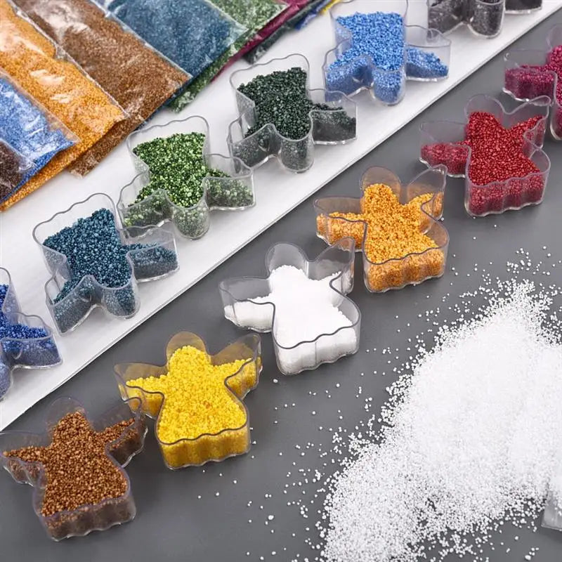 A collection of handmade candle wax kits featuring various colored sand pigments in glass containers.