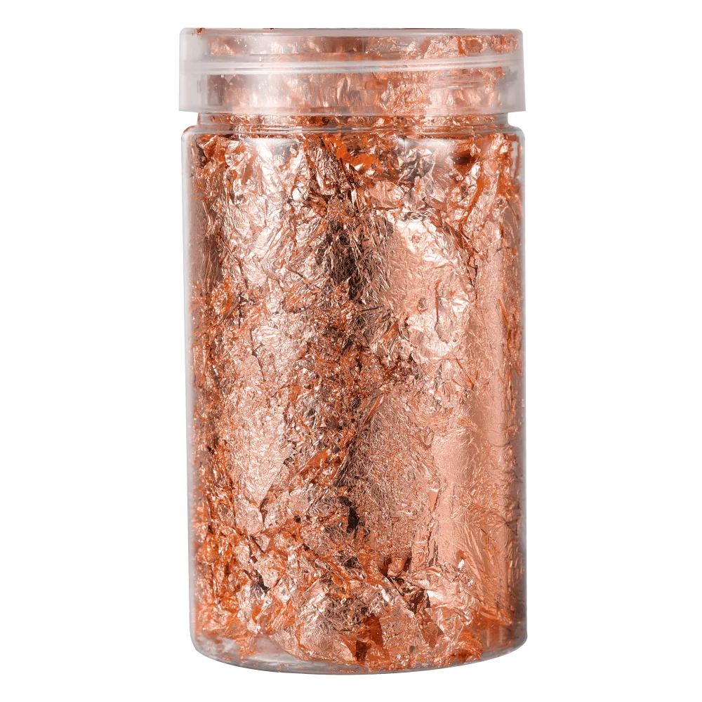 A clear jar filled with shiny gold foil flakes for resin art and jewelry making