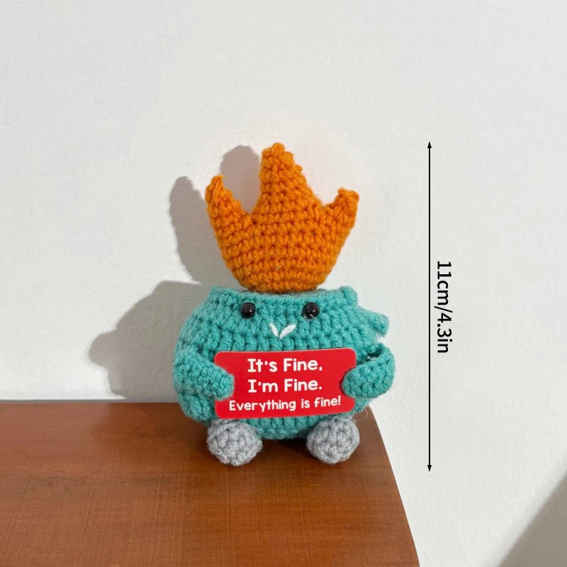 Handmade crochet potato doll in teal and gray with a red sign that says It's Fine I'm Fine Everything is fine
