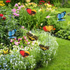 A collection of colorful butterfly garden stakes featuring orange, yellow, pink, and blue butterflies in a lush garden settin