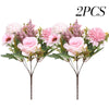 Two artificial silk rose and daisy bouquets featuring pink and purple flowers on green stems