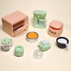 A set of realistic kitchen appliance dollhouse accessories including a pink toaster, green blender, and various small kitchen