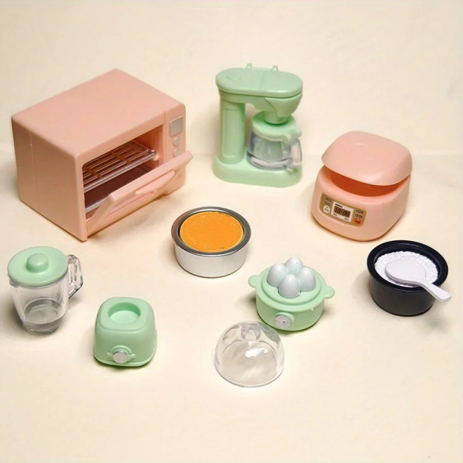 A set of realistic kitchen appliance dollhouse accessories including a pink toaster, green blender, and various small kitchen
