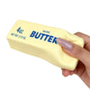 A hand is squeezing a yellow salted butter squeeze toy labeled 4oz net wt 113g.