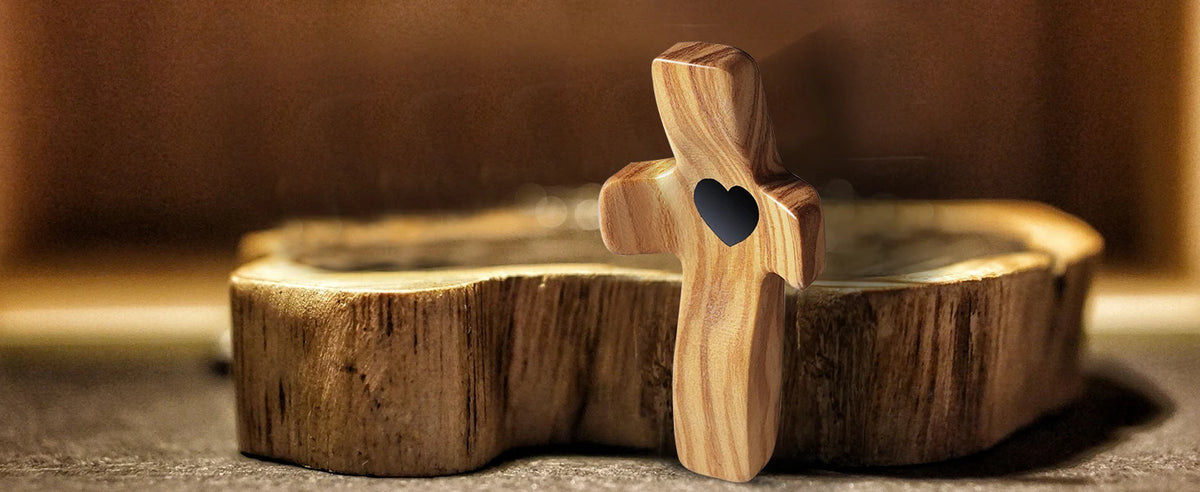 A wooden comfort prayer cross is placed in a shallow bowl, suggesting a product for anxiety relief.