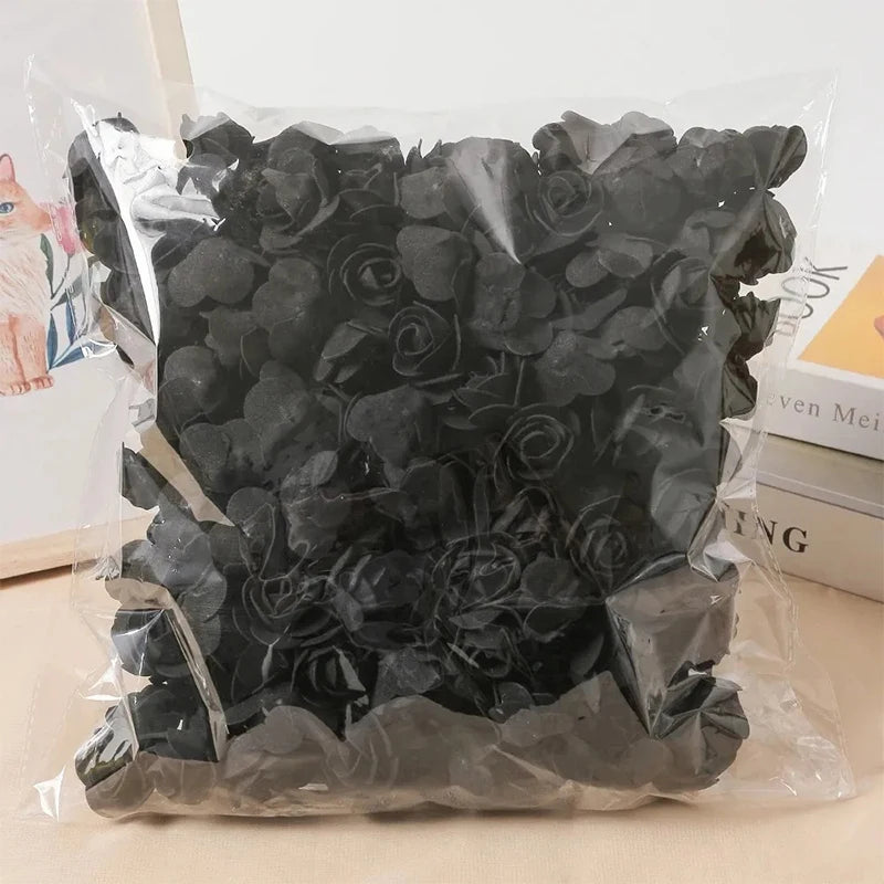 Una bolsa de plástico transparente llena de decoraciones de espuma de rosas artificiales negras.
