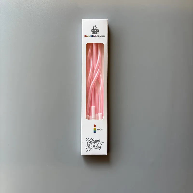 A box of rainbow candle sticks with a birthday message and six pieces inside.