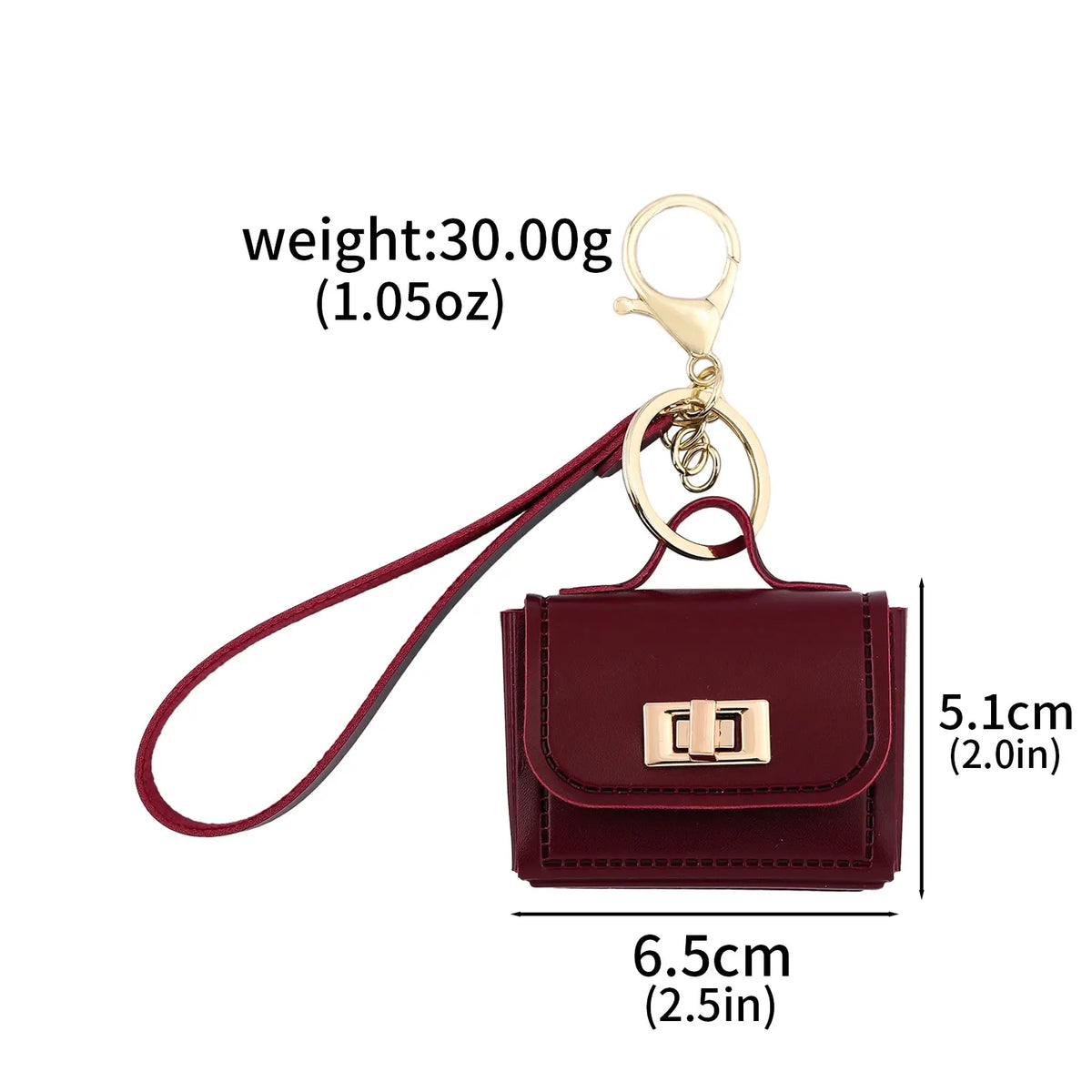 A maroon mini leather openable bag with a gold chain keychain attached.