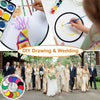 A group of people in wedding attire posing outdoors, with a drawing demonstration and a colorful disc graphic.