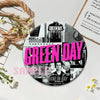 A circular button pin featuring the text GREEN DAY on a black and white background.