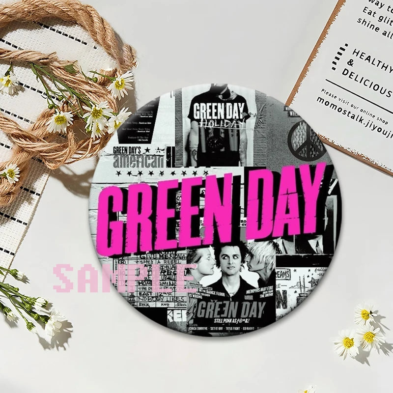 A circular button pin featuring the text GREEN DAY on a black and white background.