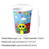 A paper cup featuring colorful cartoon characters and musical notes for a birthday party.