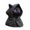 A dark, black cat statue with purple eyes wearing a hood, made of 3D printed material.