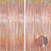 A vertical backdrop featuring shimmering metallic foil tinsel fringe in various colors.