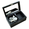 A black hand-cranked wooden music box with an open lid displaying the internal mechanism.