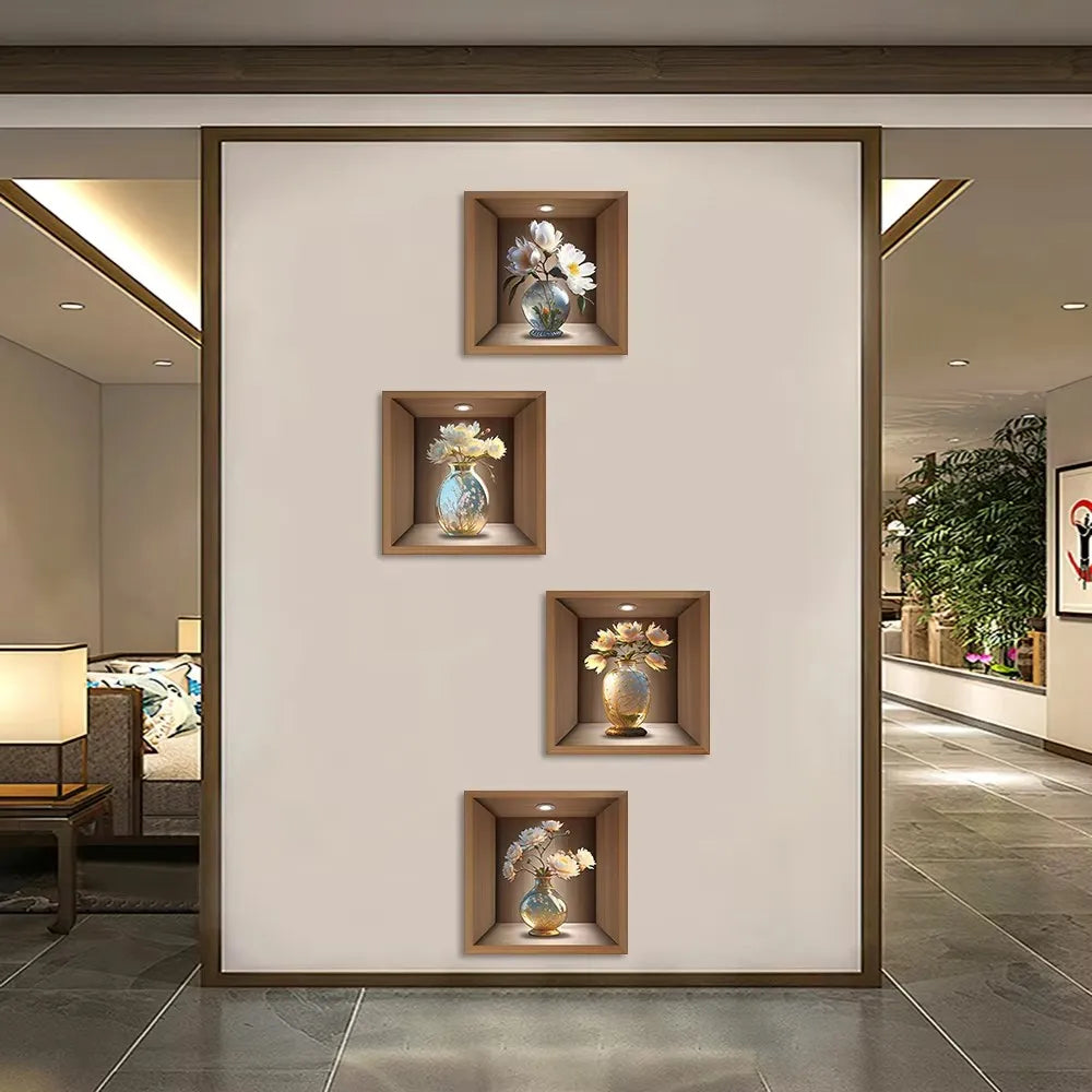 Un ensemble de décoration murale encadrée avec trois vases en verre de fleurs blanches sur un mur beige clair.