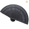 Black hand carved bamboo folding fan shown in a fan shape.