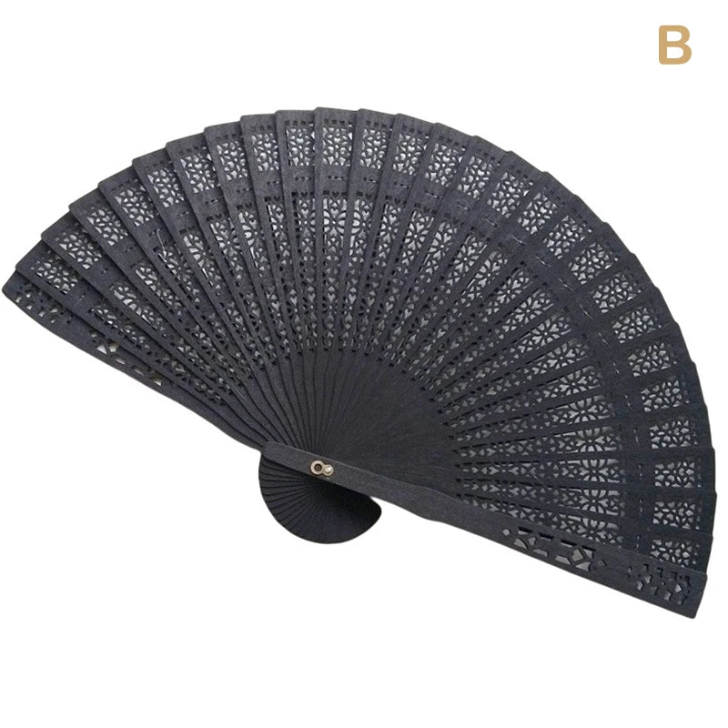 Black hand carved bamboo folding fan shown in a fan shape.
