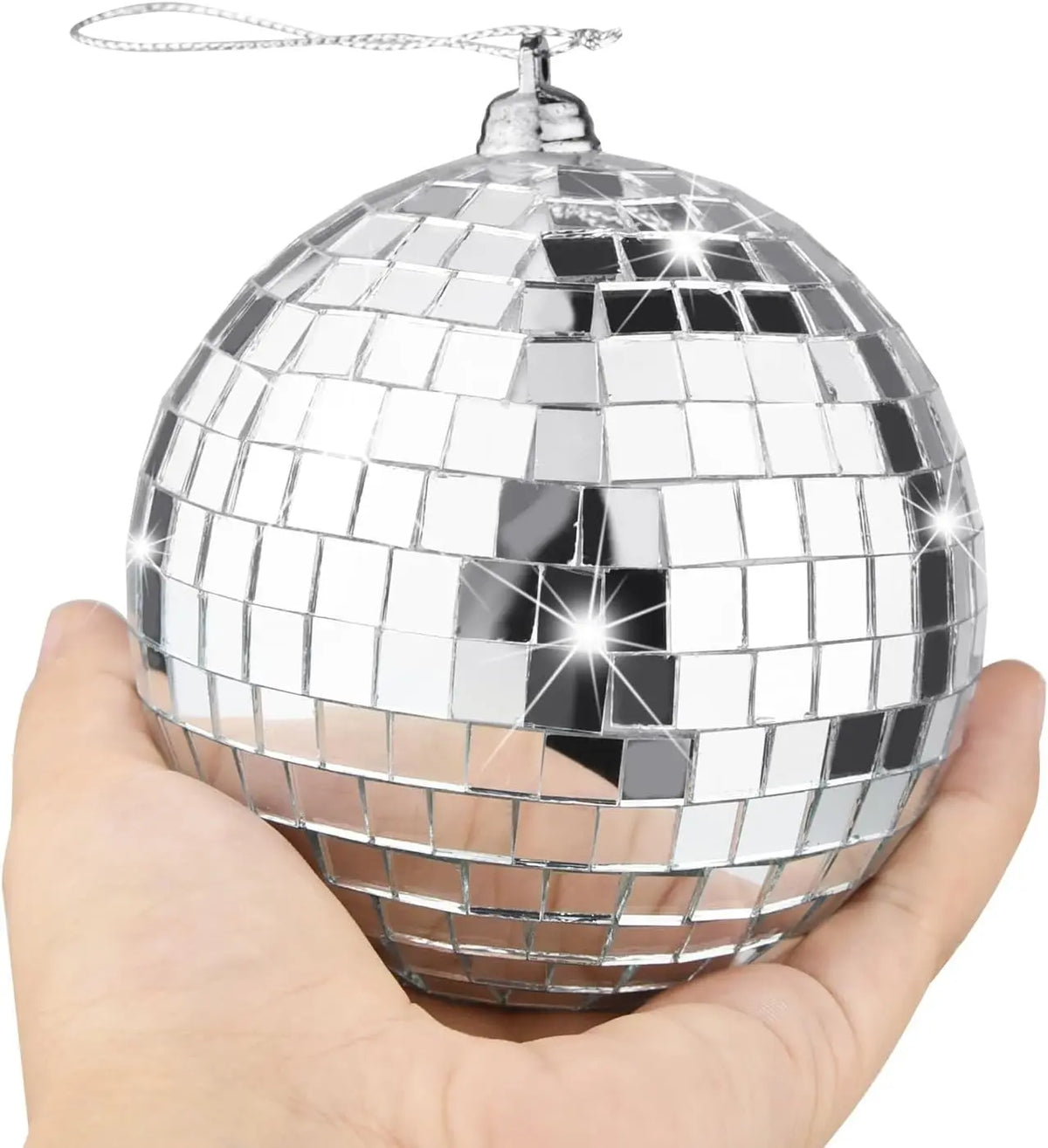 A silver mirror ball sphere with a hanging hook is held in a hand.