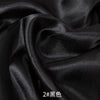 Black satin fabric draped and folded for sewing or DIY projects