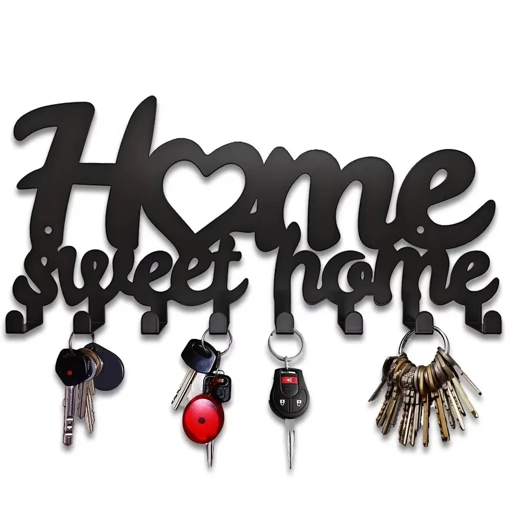 Black decorative metal wall-mounted key holder with seven hooks