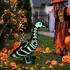 A luminous skeleton goose lawn decor is placed on green grass surrounded by autumn leaves and string lights.