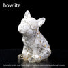 A white natural crystal dog statue in a sitting pose with gold accents.