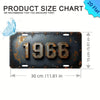 A vintage aluminum license plate tag decor with the year 1966 embossed on a dark metal background.