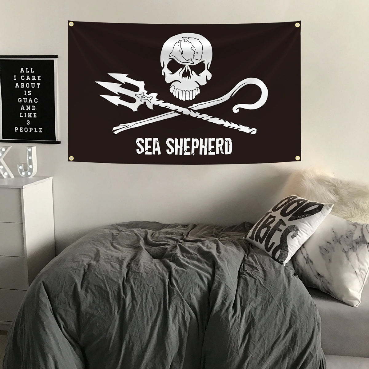 A black tapestry featuring a white skull and crossbones with a pirate sword and hook, labeled Sea Shepherd.