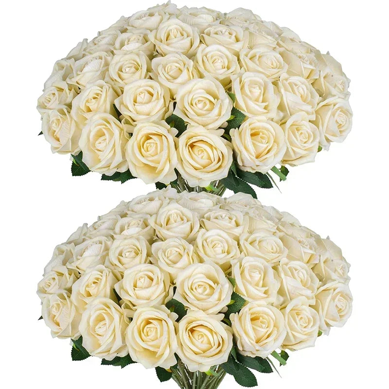 A bouquet of white artificial roses with green leaves.
