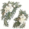 A floral arrangement featuring white roses and greenery for a wedding arch kit.