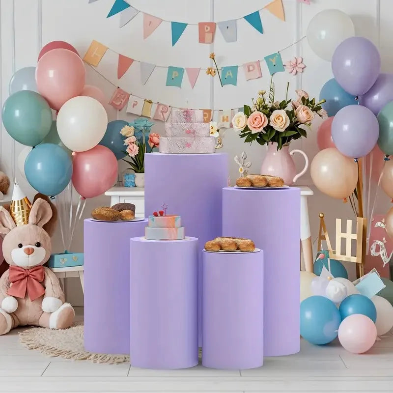 Purple elastic cylinder stands decorated with balloons and floral arrangements for party and event use