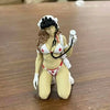 A female tactical rifleman desktop figurine wearing a white cap and holding a rifle.