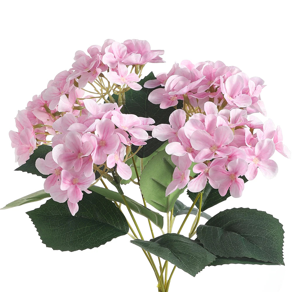 A bouquet of pink artificial hydrangea flowers with green leaves.