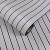 Roll of self-adhesive 3D wood grain wall panels showing vertical lines on a light gray background.