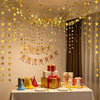 Metallic gold and silver star paper garland bunting decorating a table for a birthday celebration