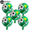 Five green soccer balloons with football graphics and gold trophies for party decoration
