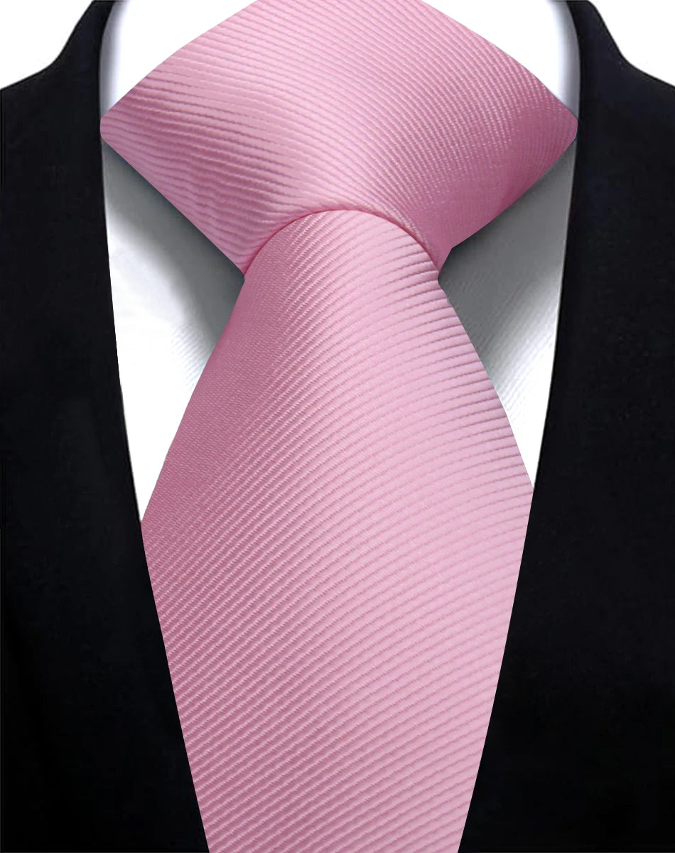 A pink silk necktie tied in a knot against a black suit jacket.