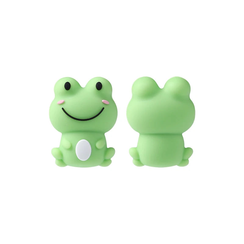 A pair of light green silicone frog-shaped beads for jewelry making and DIY crafts