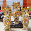Gold-plated ceramic tabletop vase with ornate floral designs and gold accents